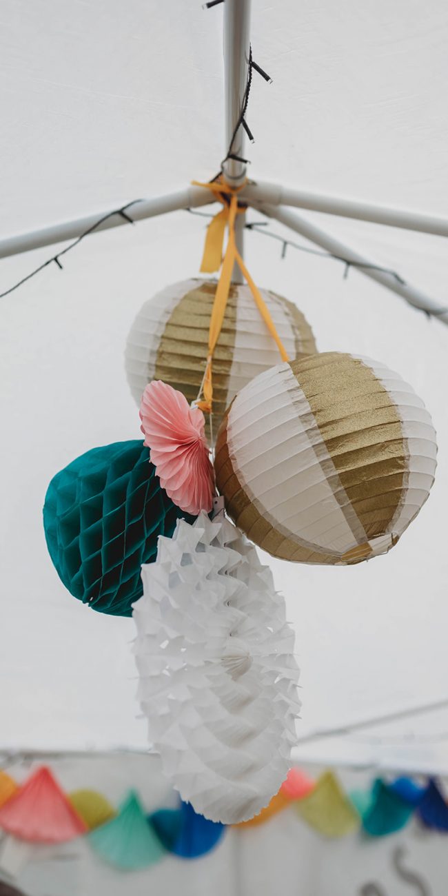 DIY wedding decorations hanging from garden marquee ceiling
