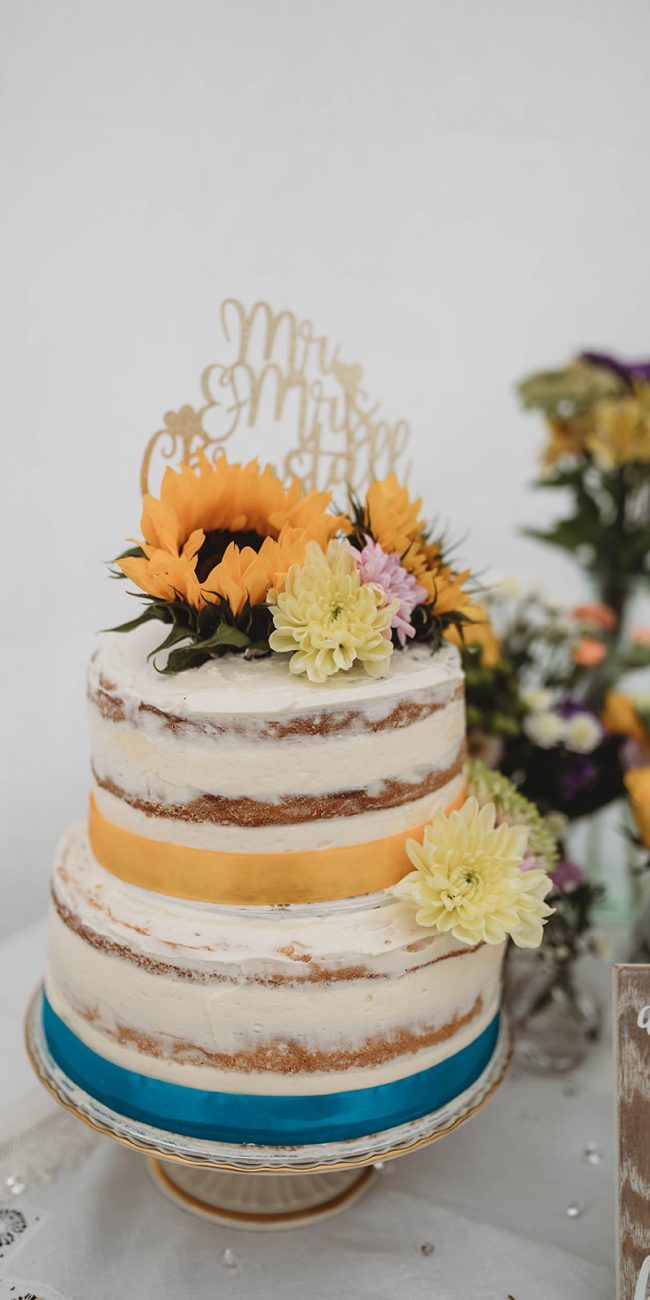 Home made smi naked wedding cake adorned with fresh flowers