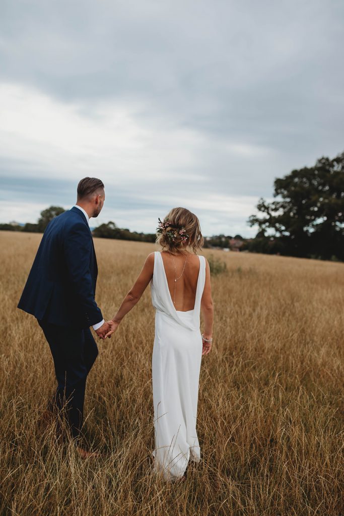 Bride and groom portrait with the bride wearing a plunging backless dress