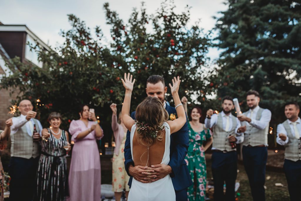 Bride and groom have their first dance on their wedding day whilst being showered with confetti canons