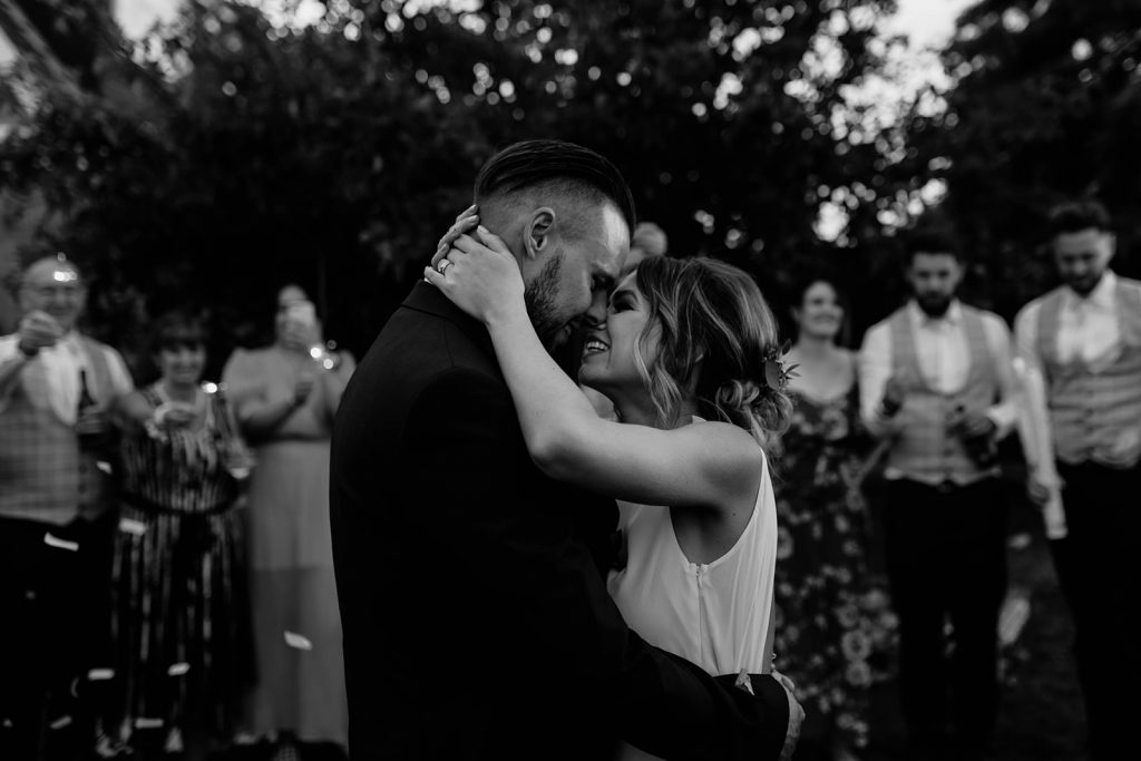 Bride and groom have their first dance on their wedding day whilst being showered with confetti canons