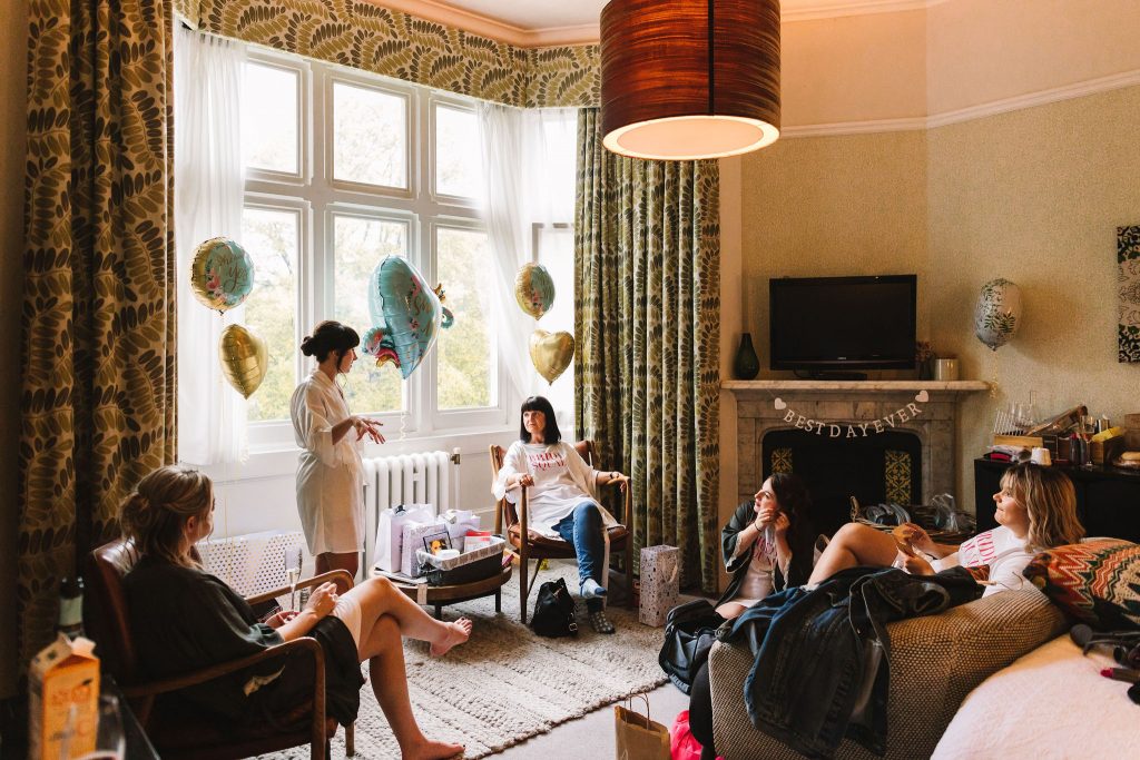 Bridal party in hotel room getting ready together on the wedding morning