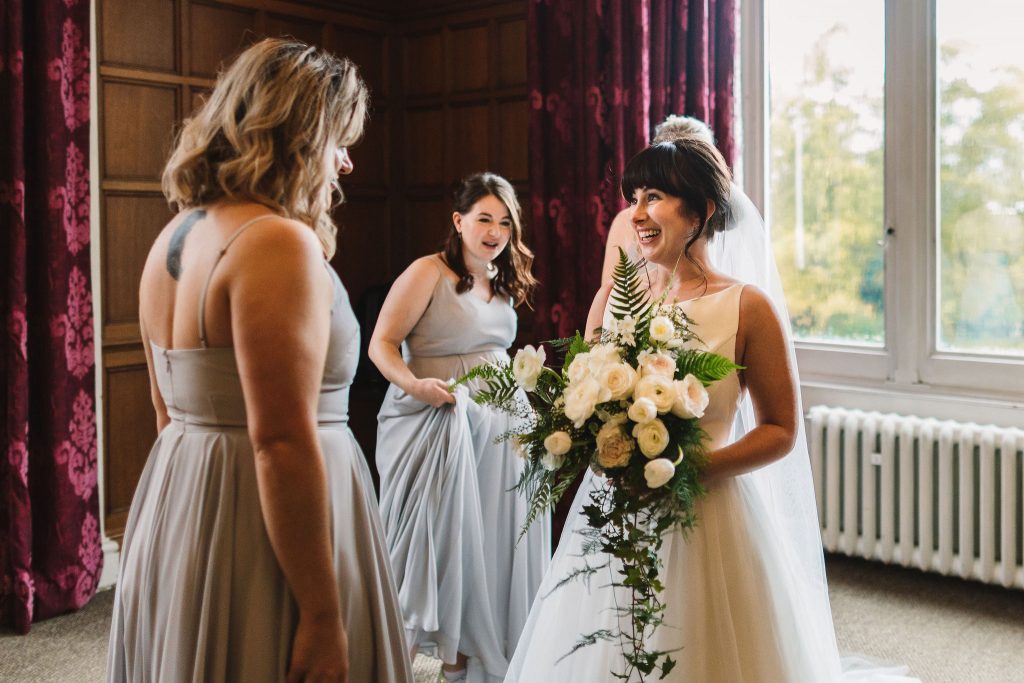 Bridal party seeing bride's wedding dress for the first time