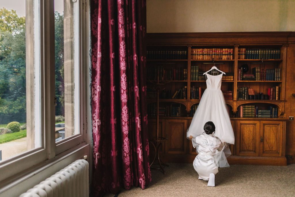 Bride admiring her wedding dress on the morning of her wedding