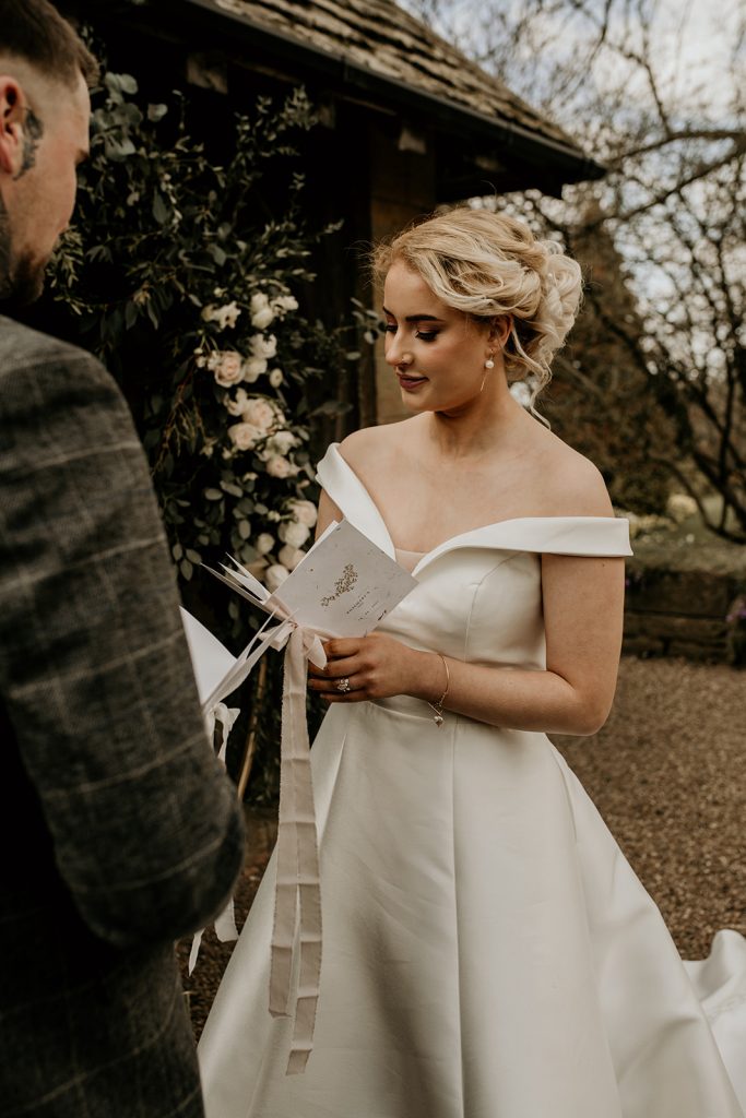 Bride and groom share a long and tender gaze during their ceremony at a country house wedding venue