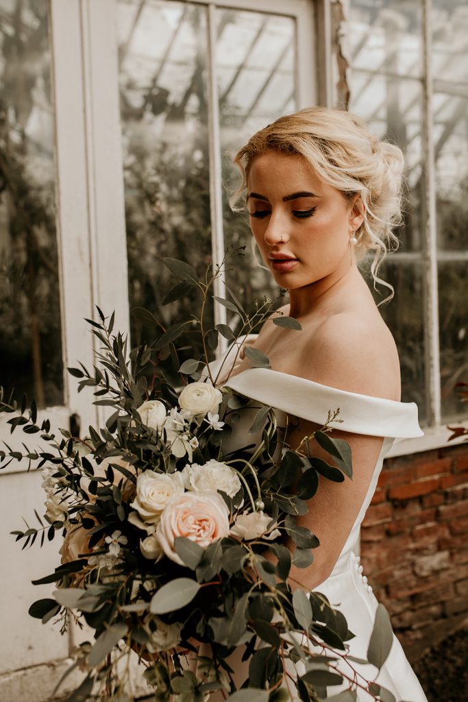 Rustic wedding bouquet of soft pinks and whites with green foliage