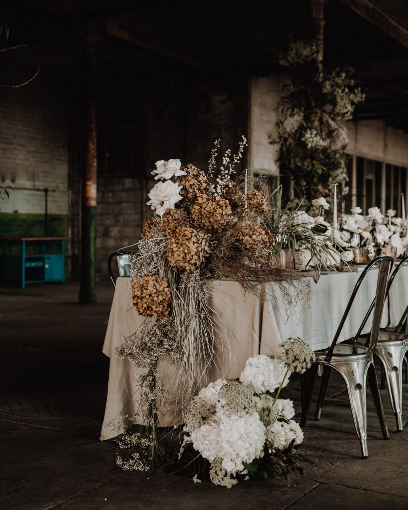 A wedding table scape of earthy tones and muted hues for an industrial micro wedding