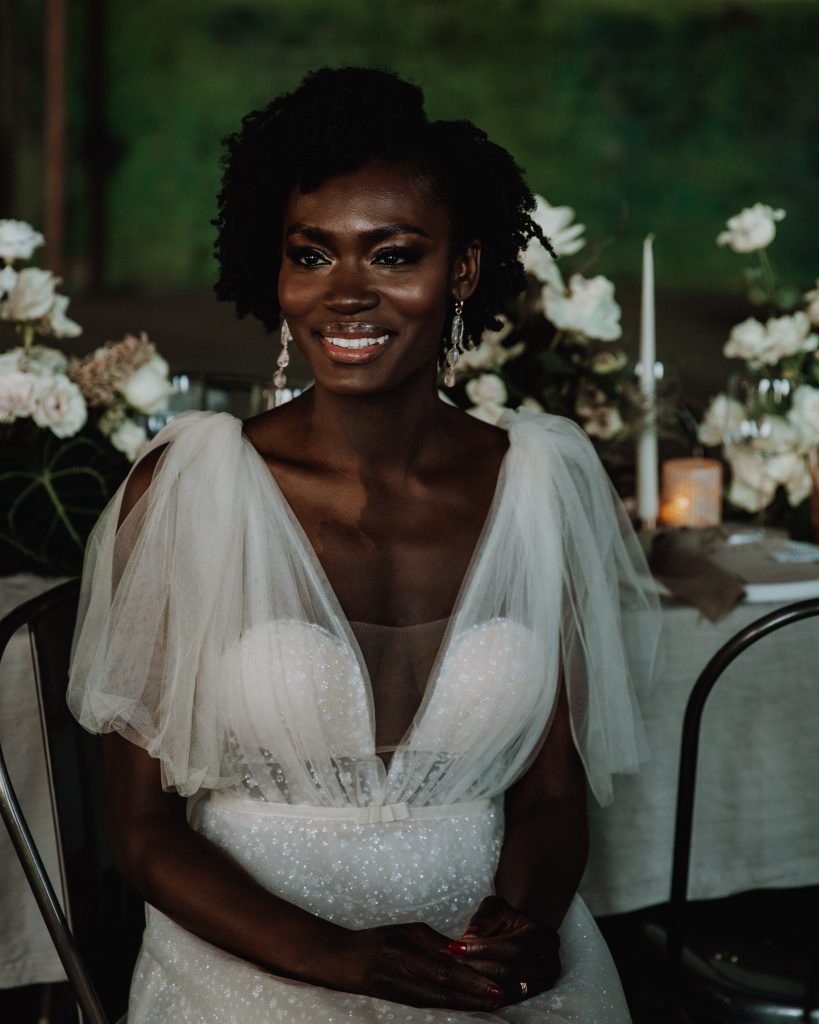 Bride in V neck plunging sparkly Berta wedding dress with tulle shoulder bows