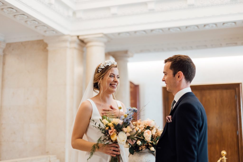 Intimate wedding couple exchange vows in civil ceremony