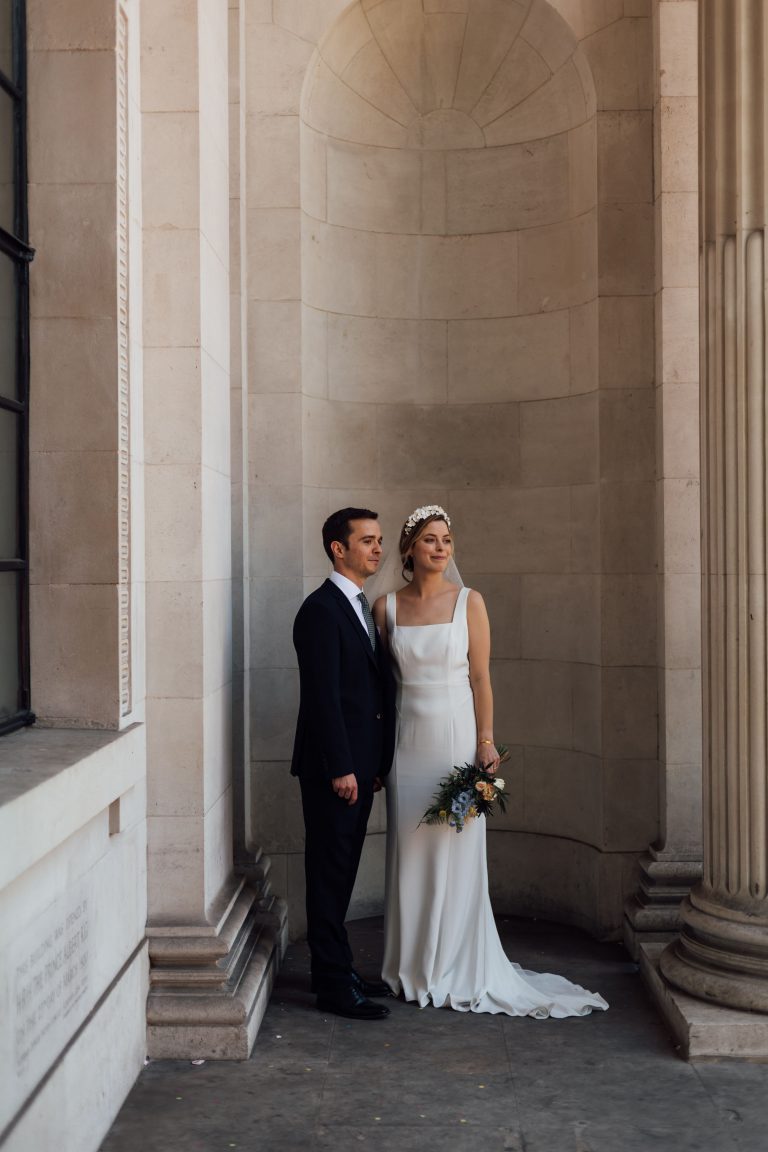 Newlywed summer micro wedding city couple pose outside The Old Marylebone Town Hall