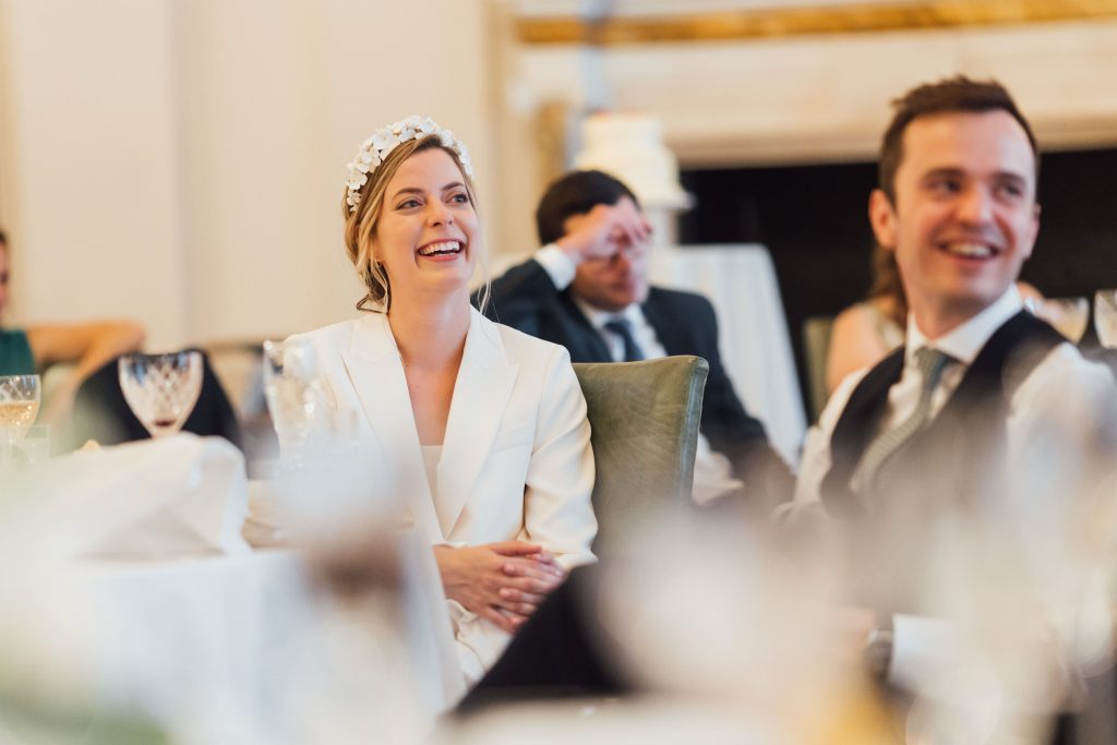 Bride laughs during wedding speeches
