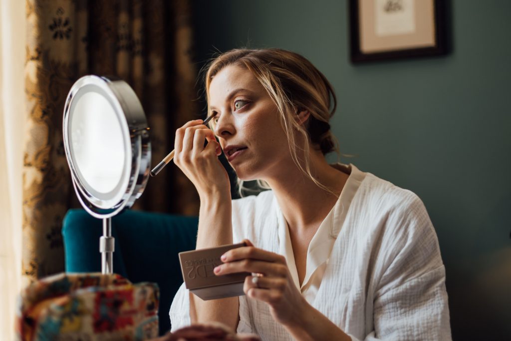 Bridal prep for city micro wedding bride as she does her own wedding day make up