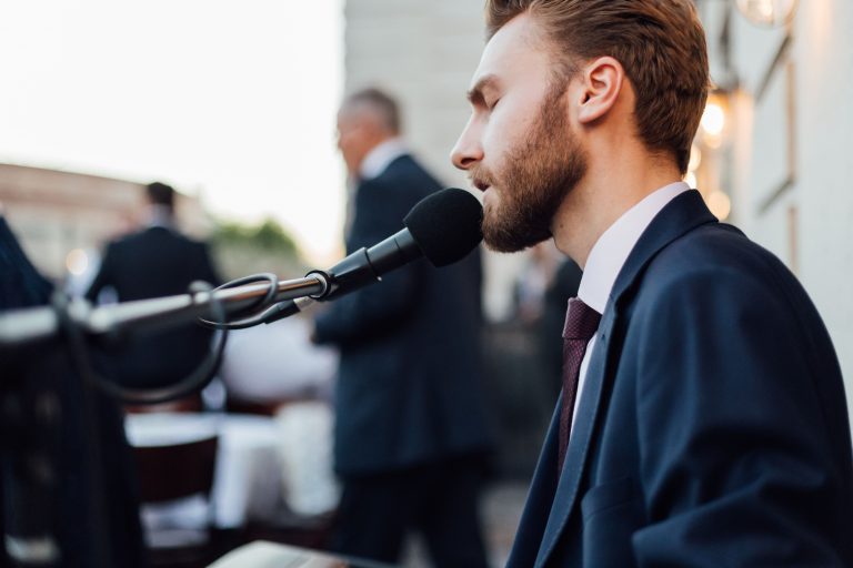 Singer and pianist plays music at The Ned's rooftop city terrace for summer micro wedding