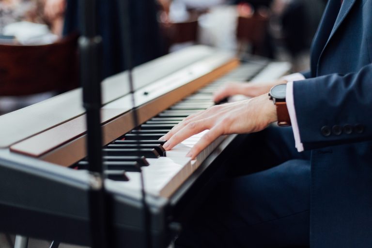 Singer and pianist plays music at The Ned's rooftop city terrace for summer micro wedding