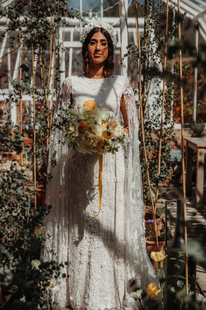 Bride in white Julita LDN Bride standing in the Victorian glasshouse in a country house manor wedding venue