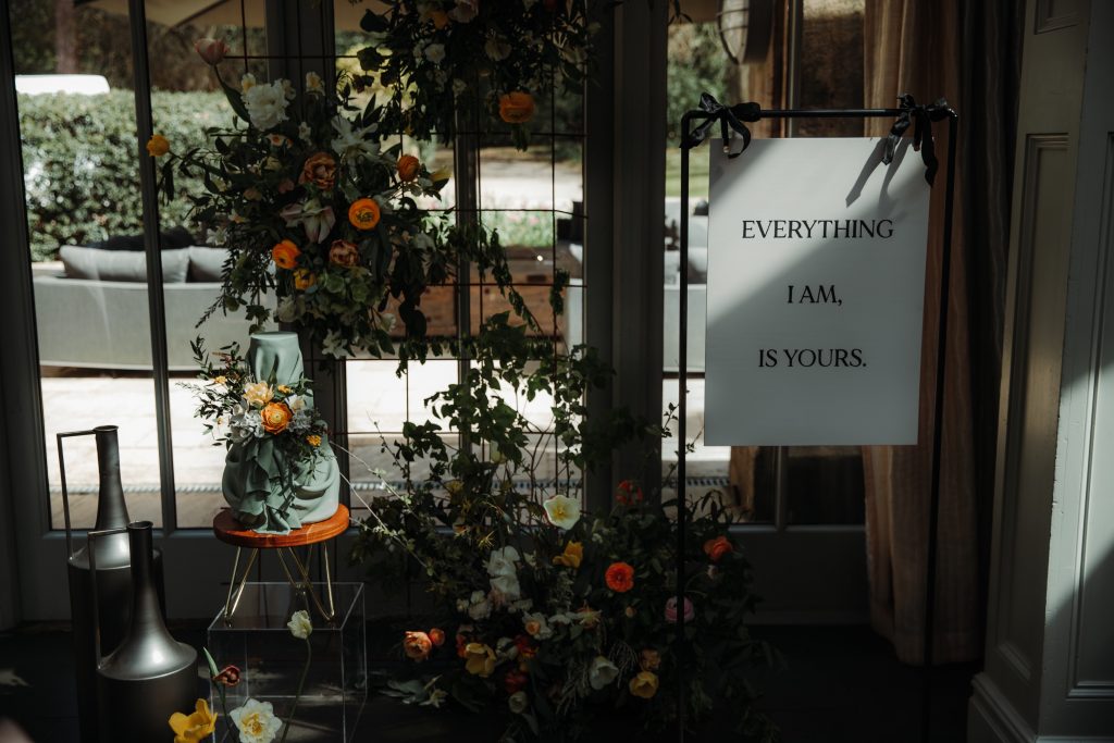 Large hanging wedding sign that reads "Everything I am, is yours"