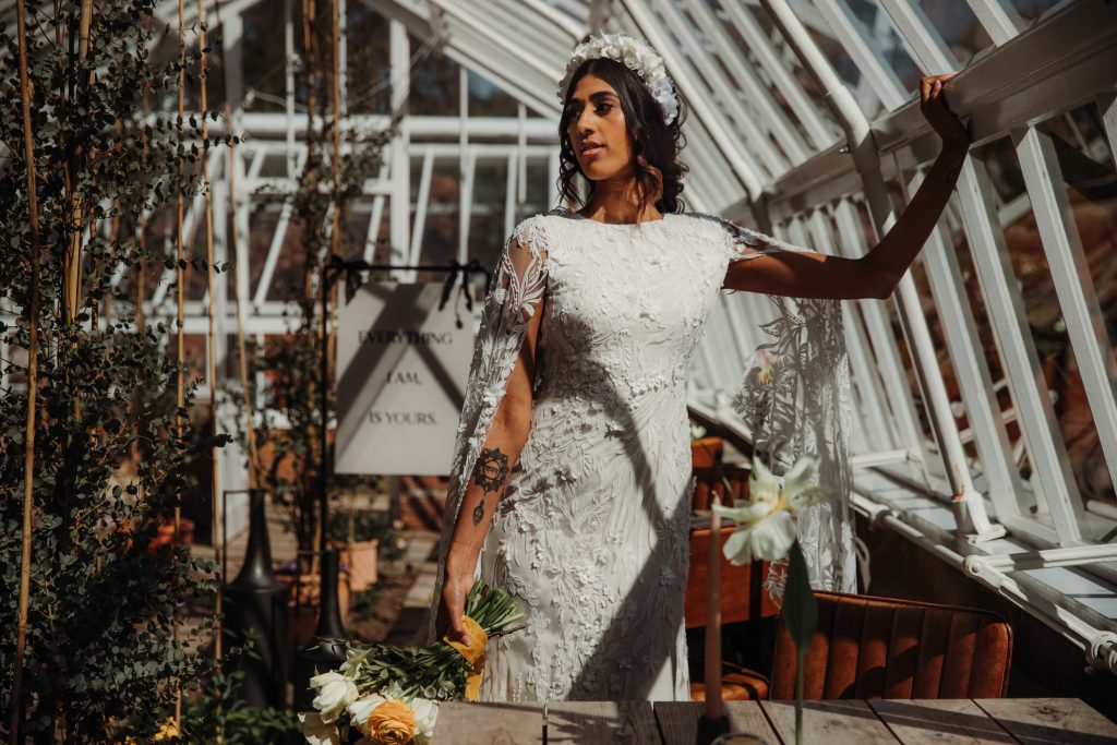 Alternative bride in white wedding dress with embellished wedding headband