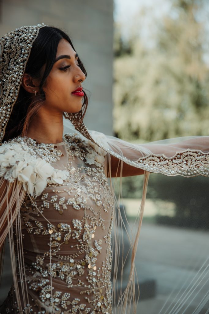 Heavily embellished exquisite wedding dress for non traditional bride with hand beaded veil