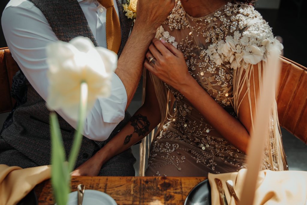 Close up of a tender embrace between a husband and wife on their wedding day