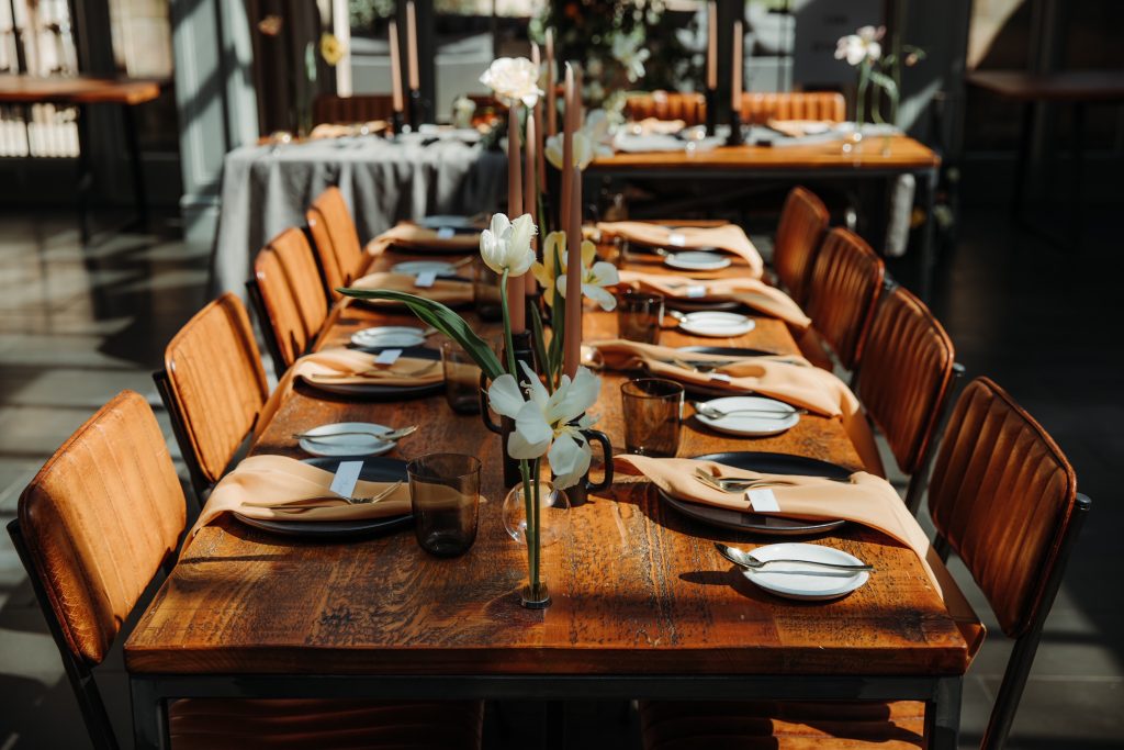 Wooden table wedding styling for spring wedding with colour palette of muted yellows and blacks