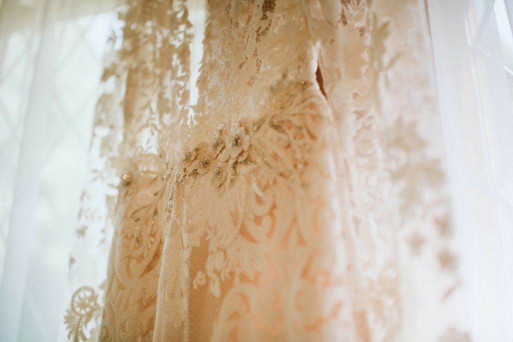 Liz Martinez wedding gown hanging up before bridal prep