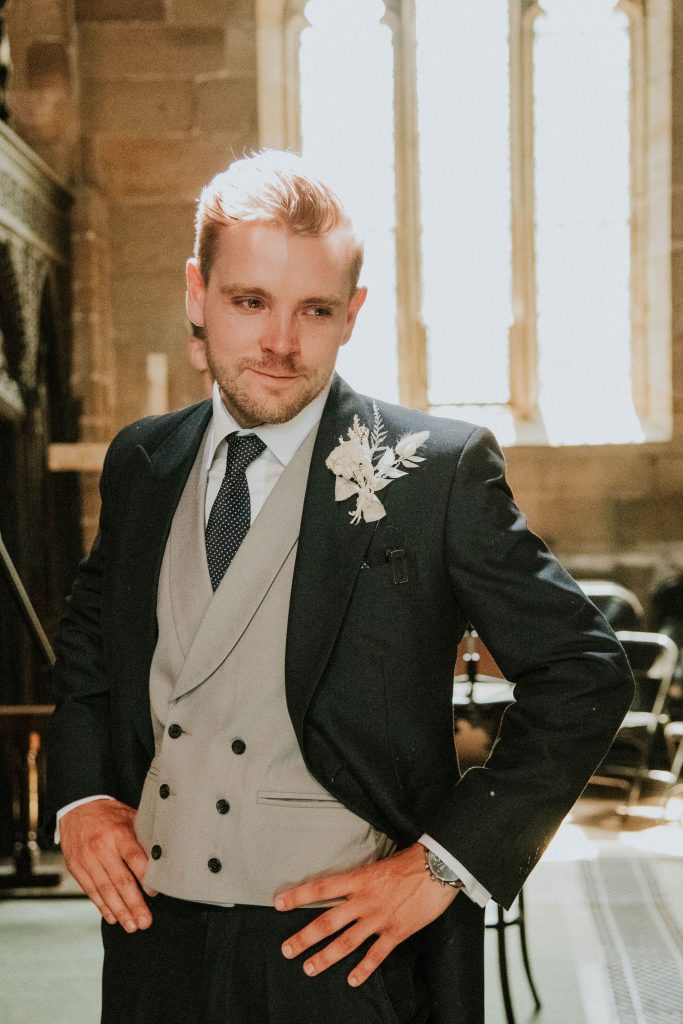 Teary eyed groom sees bride for the first time during Church wedding service