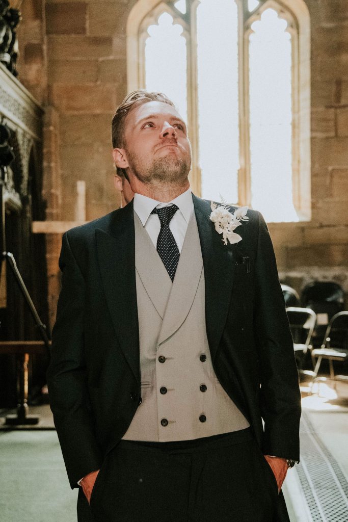 Teary eyed groom sees bride for the first time during Church wedding service