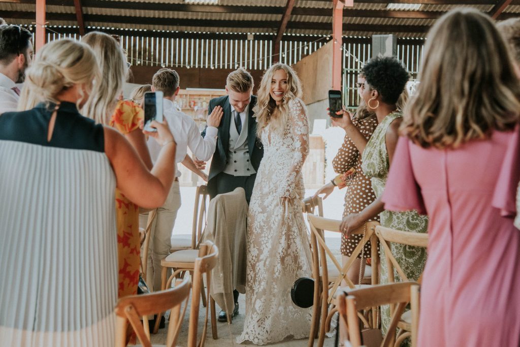 Bride and groom make their entrance for their wedding breakfast
