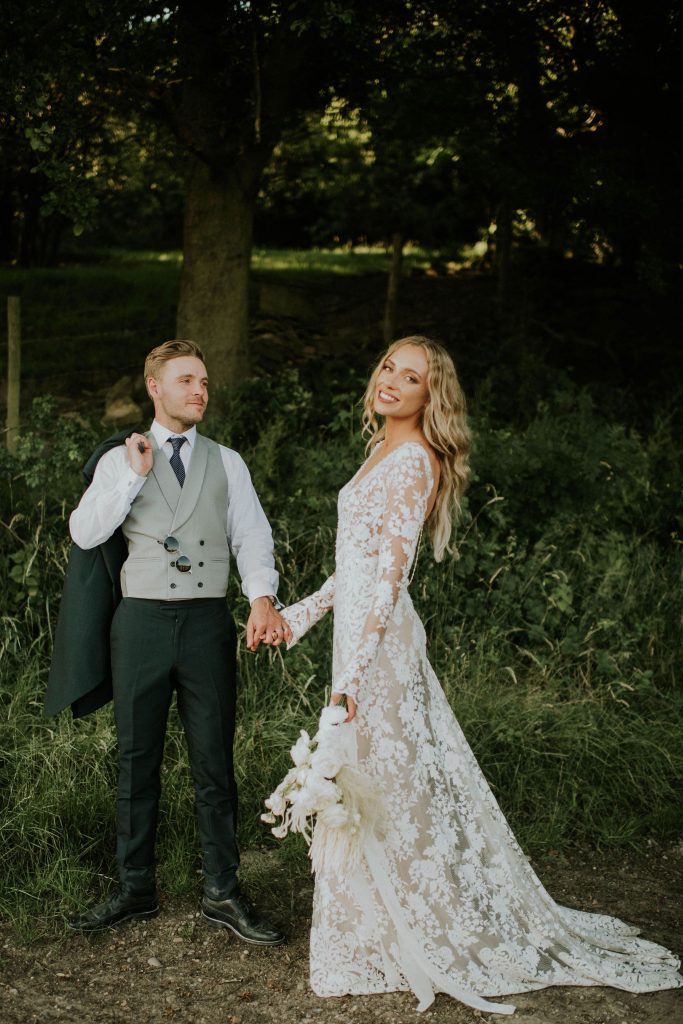 Newlywed couple holding hands on their wedding day