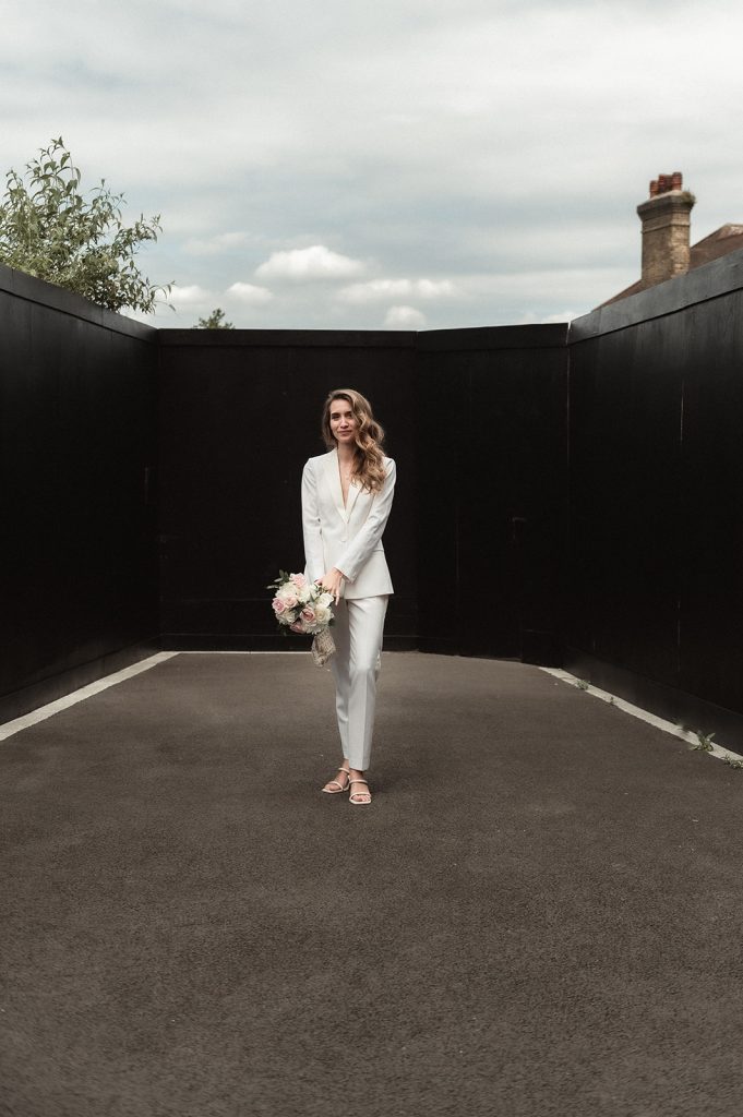 Chic stylish bride in white bridal suit