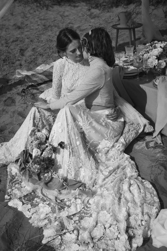 Two newlywed brides in sunset beach wedding elopement