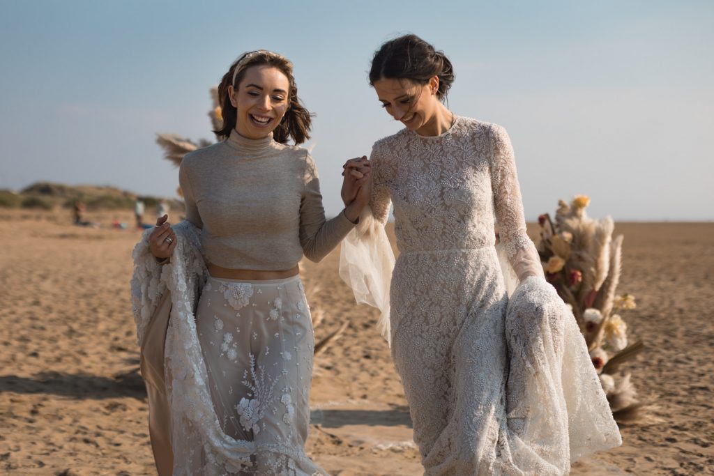 Bride and Bride in sunset beach elopement with pampas styling
