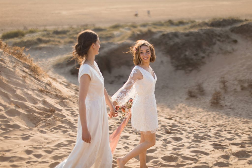 Bride and Bride in sunset beach elopement with pampas styling