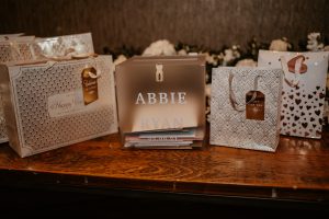 Frosted, personalised acrylic cube wedding card box sat on wedding present table