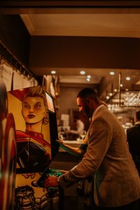Wedding guest enjoying the retro arcade games during a wedding party