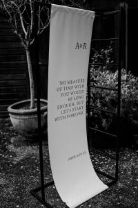 Modern cloth wedding day quote signage in black writing on white