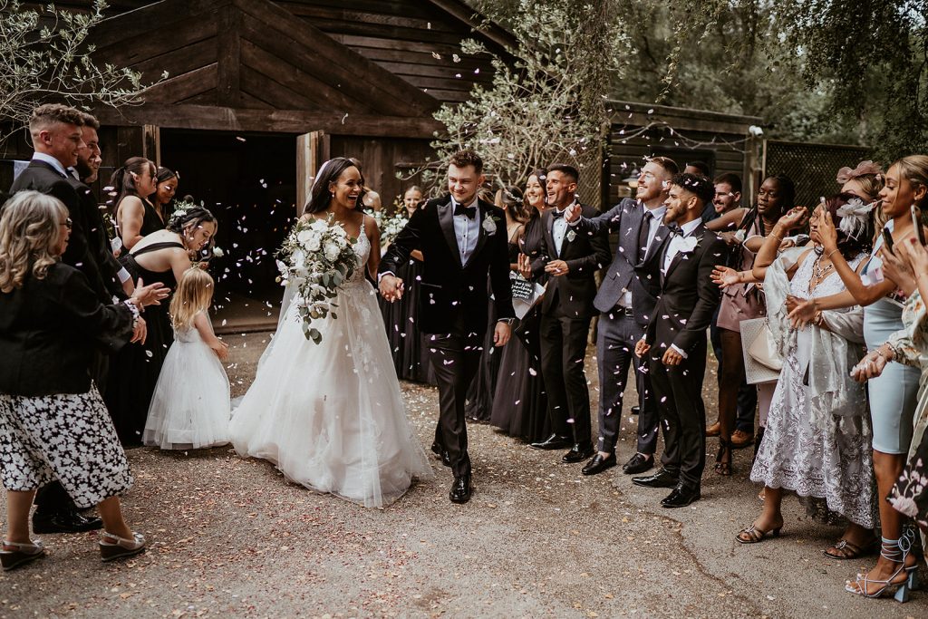 Confetti being thrown over a newly wed couple emerging from their civil ceremony room