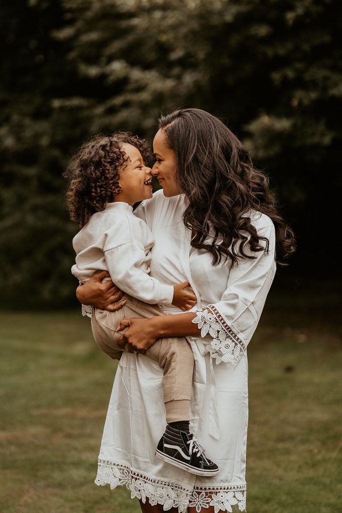 A bride to be cuddles with her young son on her wedding morning during bridal prep