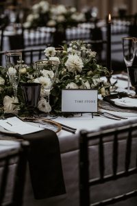 Black and white contemporary wedding table styling with hints of gold and greenery for luxury country house wedding