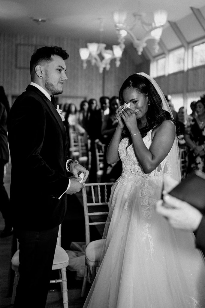 A bride wipes away tears during an emotional wedding ceremony