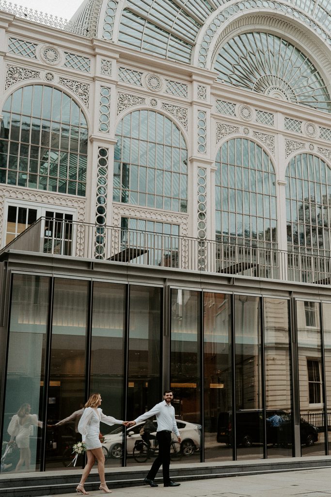 A newly married bride and groom wandering the streets of London during their city elopement
