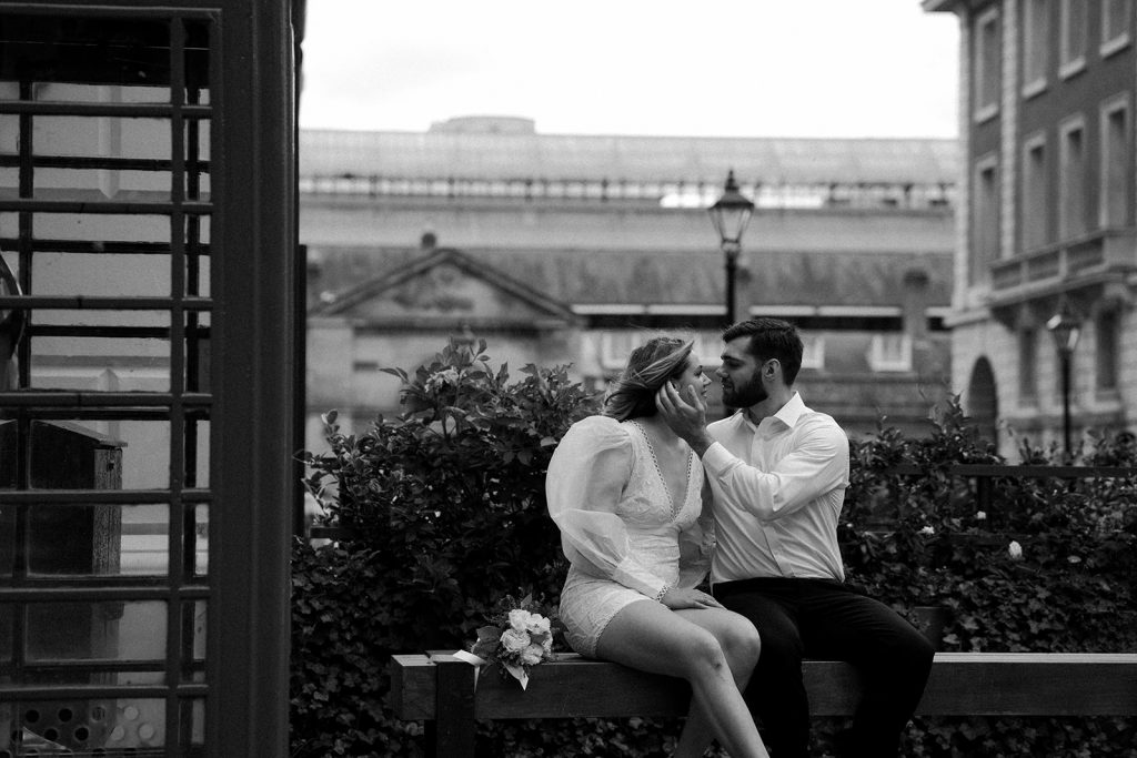 A newly wed bride and groom share a gentle embrace during their city elopement