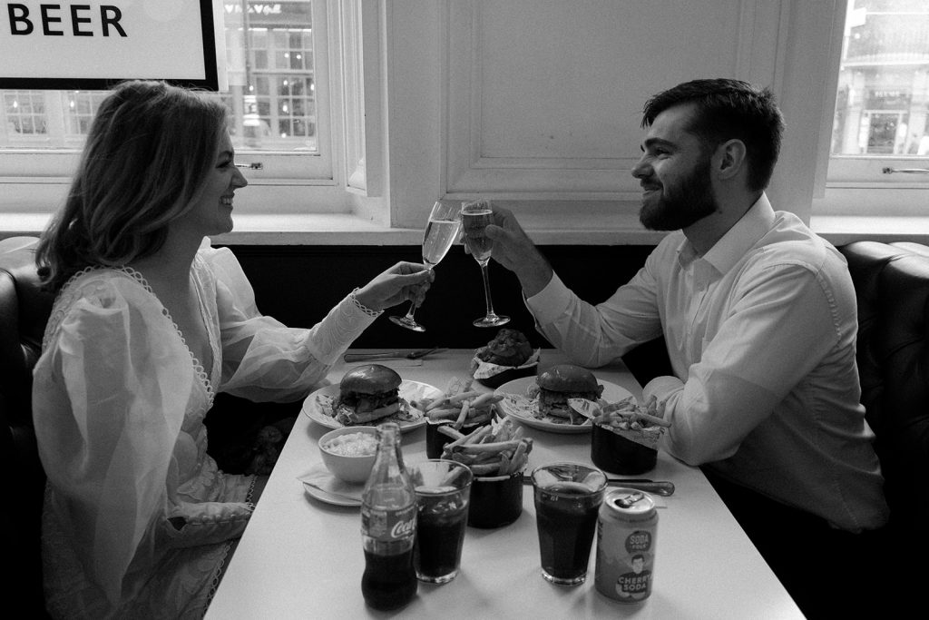 Bride and groom cheers one another with a glass of Champagne on their wedding day