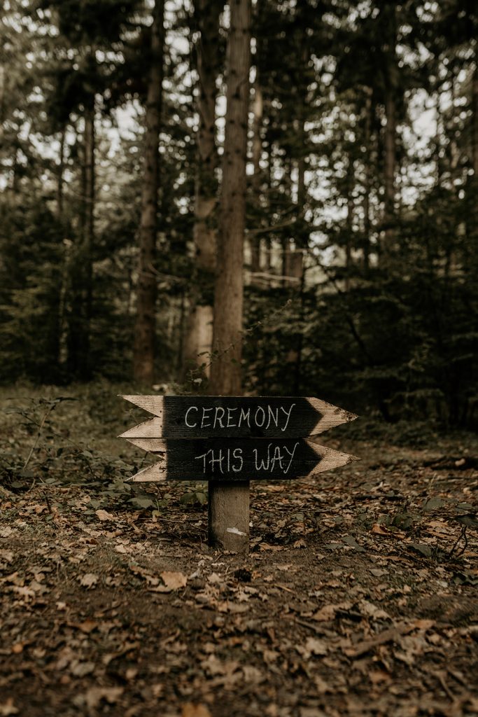 Wooden wedding signage for outdoor forest wedding ceremony