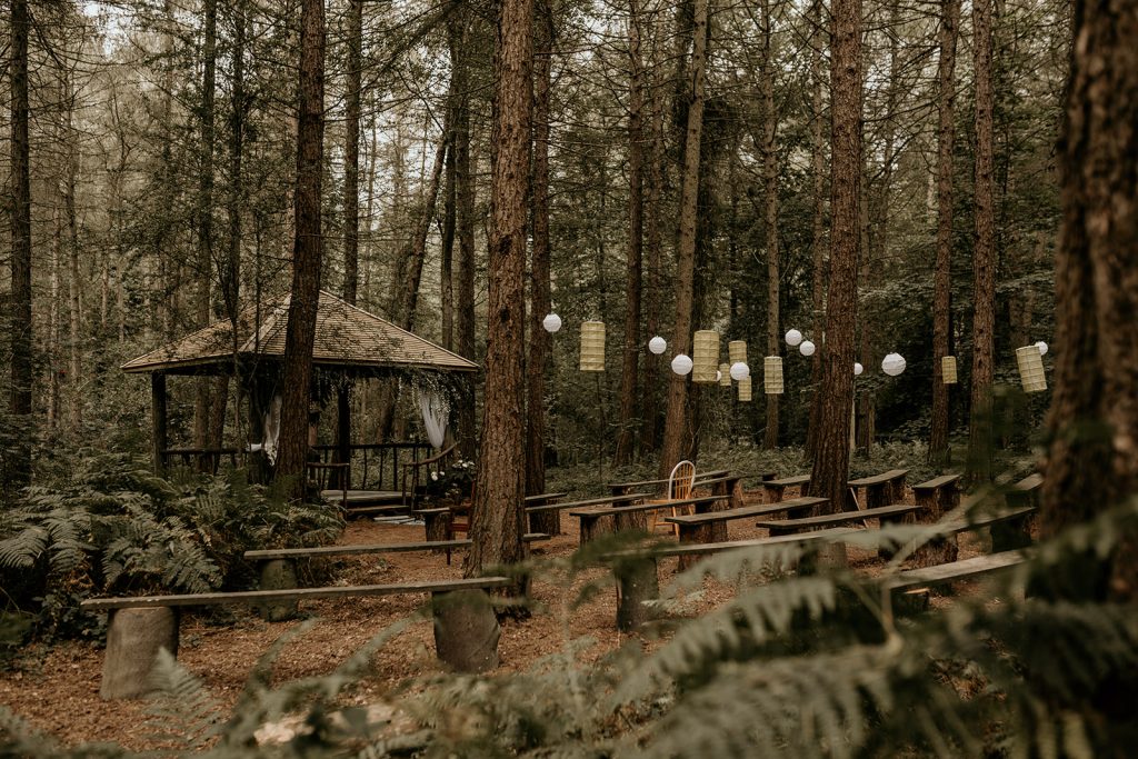 The woodland ceremony setting for Aimee and Rob's modern boho wedding
