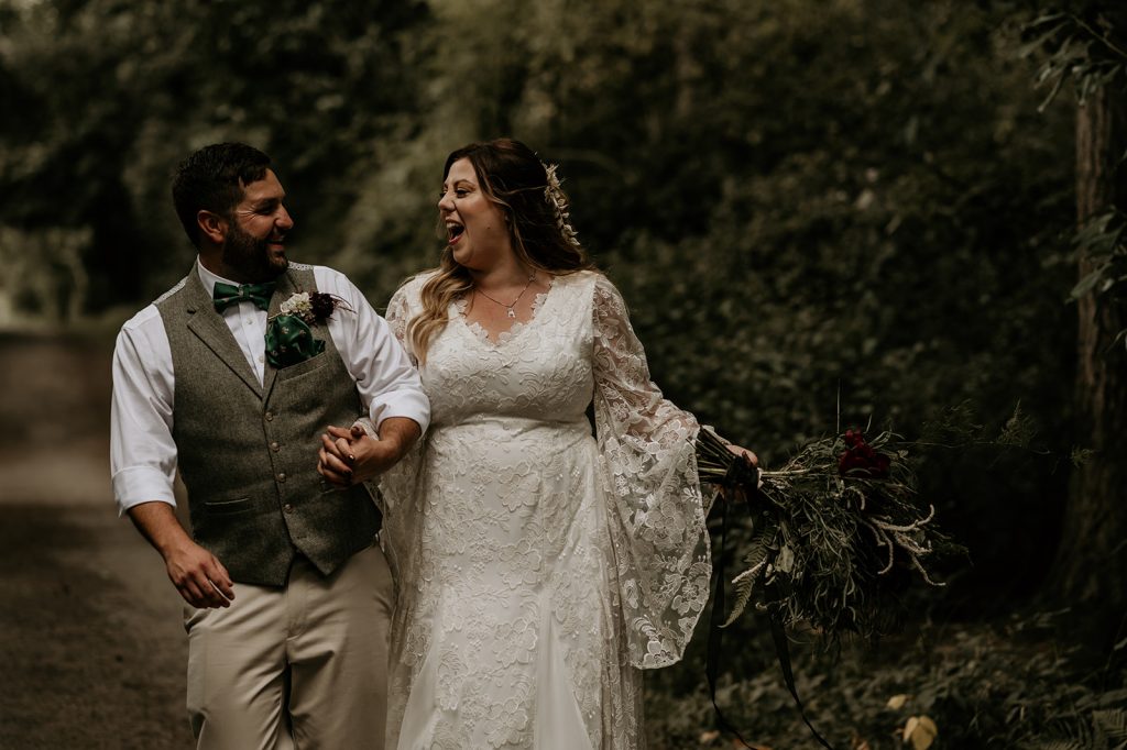 Modern boho wedding couple enjoying some aloe time in the forest shortly after their woodland ceremony