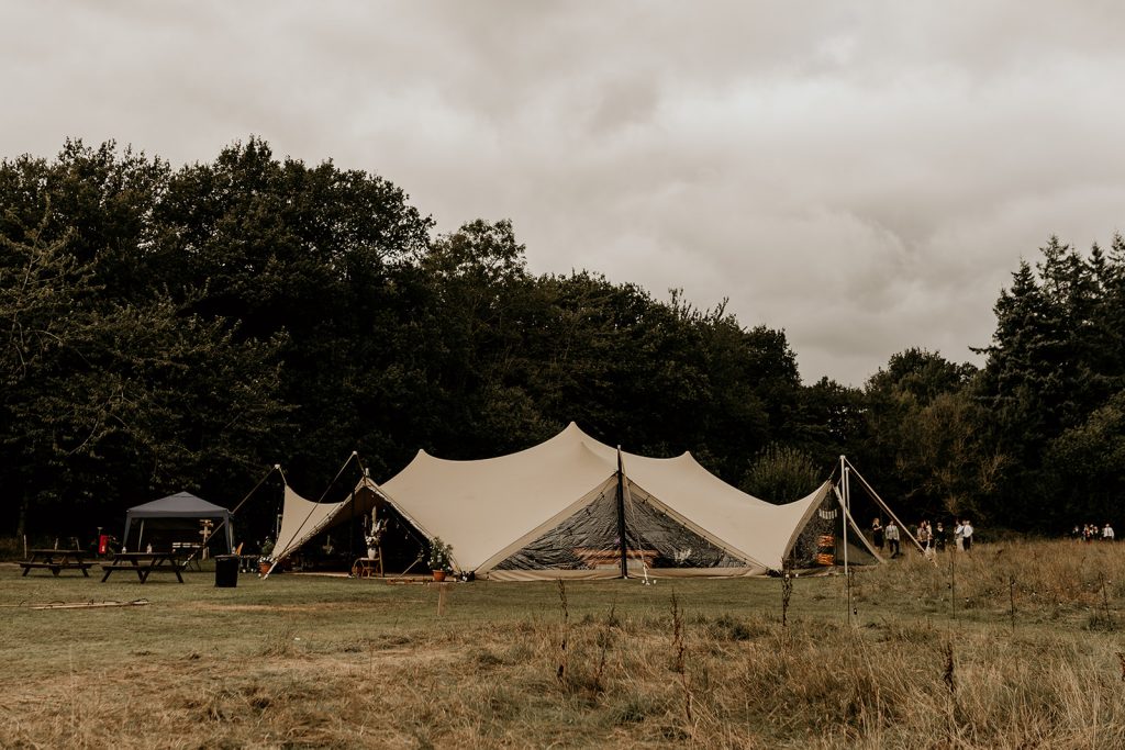 Marquee wedding structure in open field for modern boho wedding