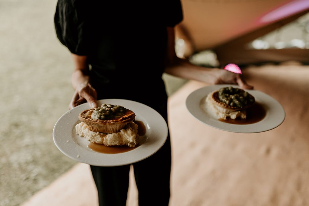 Pie and mash being served to wedding guests during informal and relaxed boho wedding
