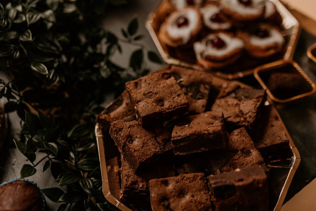 Dessert table with homemade treats for wedding cake table for rustic boho wedding couple