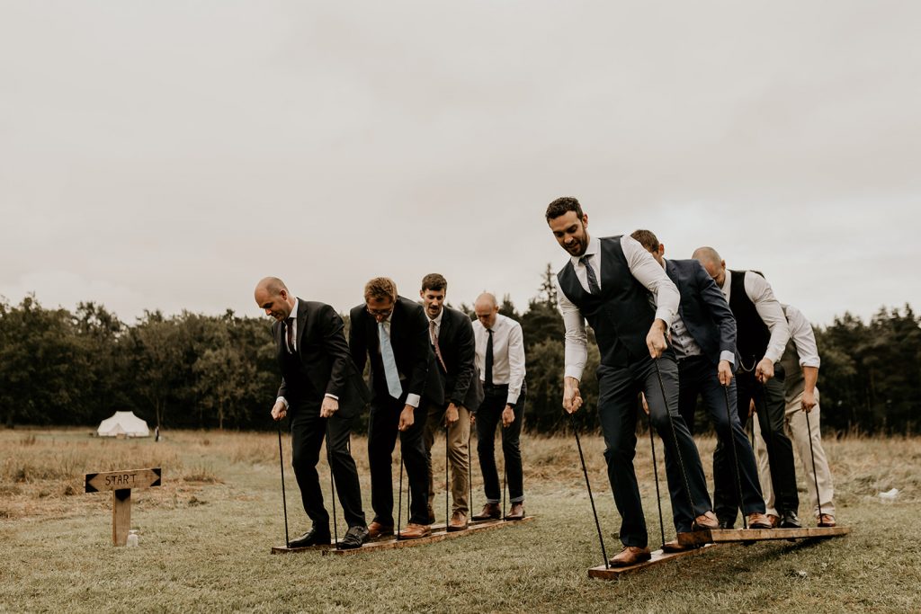 Guests enjoy outdoor games during informal and relaxed boho wedding